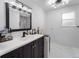 Modern bathroom with dark vanity and marble flooring at 4220 19Th N St, St Petersburg, FL 33714