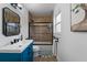 Updated bathroom with a blue vanity, tub shower combo, and stylish mirror at 4220 19Th N St, St Petersburg, FL 33714