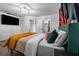 Spacious bedroom with a green velvet headboard and orange blanket at 4220 19Th N St, St Petersburg, FL 33714