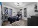 Cozy bedroom with dark wood flooring, black accents, and patterned curtains at 4220 19Th N St, St Petersburg, FL 33714