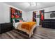 Spacious bedroom with a green velvet headboard, patterned curtains, and dark wood flooring at 4220 19Th N St, St Petersburg, FL 33714