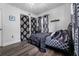 Well-lit bedroom with dark flooring, black accents, and patterned curtains at 4220 19Th N St, St Petersburg, FL 33714