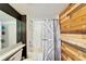 Clean bathroom with a white bathtub and a rustic wood-paneled wall at 4501 Keene Rd, Plant City, FL 33565