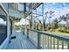 Long wooden deck with a view of the backyard and surrounding nature at 4501 Keene Rd, Plant City, FL 33565
