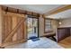 Interior entryway with sliding barn door and view to back porch at 4501 Keene Rd, Plant City, FL 33565