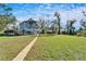 Elevated home, large grassy yard, and walkway leading to house at 4501 Keene Rd, Plant City, FL 33565