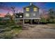 Two-story house exterior at dusk, elevated, screened porch, and large yard at 4501 Keene Rd, Plant City, FL 33565