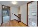 Upstairs hallway with wood floors and doors to rooms and bath at 4501 Keene Rd, Plant City, FL 33565