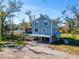 Two-story light blue house with a metal carport and screened porch at 4501 Keene Rd, Plant City, FL 33565