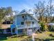 Two-story light blue house with large deck and metal carport at 4501 Keene Rd, Plant City, FL 33565