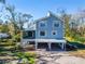 Two-story light blue house with a metal carport at 4501 Keene Rd, Plant City, FL 33565