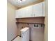 Laundry room with washer/dryer hookups and overhead cabinets at 4501 Keene Rd, Plant City, FL 33565