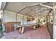 Rustic outdoor kitchen with long wooden table at 4501 Keene Rd, Plant City, FL 33565