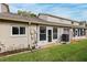View of the back of the house, with a patio, grassy area, and AC unit at 6506 Remus Dr, New Port Richey, FL 34653