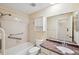 Clean bathroom with a shower/tub combo and granite countertop at 6506 Remus Dr, New Port Richey, FL 34653