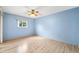 Bright bedroom with light blue walls, wood-look floors, and a ceiling fan at 6506 Remus Dr, New Port Richey, FL 34653