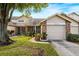 Front view of the house, showing the garage and landscaping at 6506 Remus Dr, New Port Richey, FL 34653