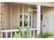Front porch with white columns, ceiling fan, and bay window at 6506 Remus Dr, New Port Richey, FL 34653