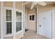Front porch with white columns, ceiling fan, and bay window at 6506 Remus Dr, New Port Richey, FL 34653