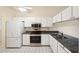 Kitchen with white cabinets, granite counters, and stainless steel appliances at 6506 Remus Dr, New Port Richey, FL 34653