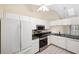 Kitchen with white cabinets, granite counters, and stainless steel appliances at 6506 Remus Dr, New Port Richey, FL 34653