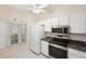 Kitchen with white cabinets, granite counters, and stainless steel appliances at 6506 Remus Dr, New Port Richey, FL 34653