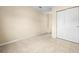 Empty bedroom with double door closet and tile floor at 9104 Sandcroft Ct, Tampa, FL 33615
