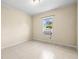 Simple bedroom with window unit and tile floor at 9104 Sandcroft Ct, Tampa, FL 33615