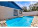 Inviting blue swimming pool with stone coping at 9104 Sandcroft Ct, Tampa, FL 33615