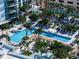 Expansive pool and patio area with numerous lounge chairs and palm trees at 100 1St N Ave # 1601, St Petersburg, FL 33701