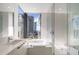 Modern bathroom with a glass shower, marble walls, and a white vanity at 100 1St N Ave # 1601, St Petersburg, FL 33701