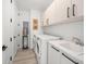 Bright laundry room with washer, dryer, and cabinets at 100 1St N Ave # 1601, St Petersburg, FL 33701