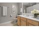 Clean bathroom with light wood vanity, white tile, and neutral decor at 12055 Gandy N Blvd # 243, St Petersburg, FL 33702