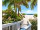 Walkway to the beach with lush landscaping and white sand at 12055 Gandy N Blvd # 243, St Petersburg, FL 33702