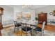 Bright dining room with glass-top table, six chairs, and hardwood floors at 12055 Gandy N Blvd # 243, St Petersburg, FL 33702