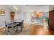 Open concept dining area with hardwood floors and view into kitchen at 12055 Gandy N Blvd # 243, St Petersburg, FL 33702