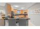 Modern kitchen with light wood cabinets, granite counters, and stainless steel appliances at 12055 Gandy N Blvd # 243, St Petersburg, FL 33702