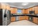 Modern kitchen with stainless steel appliances and light wood cabinets at 12055 Gandy N Blvd # 243, St Petersburg, FL 33702