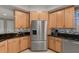 Modern kitchen with stainless steel appliances and light wood cabinets at 12055 Gandy N Blvd # 243, St Petersburg, FL 33702