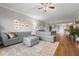 Spacious living room featuring a sectional sofa, large area rug, and hardwood floors at 12055 Gandy N Blvd # 243, St Petersburg, FL 33702