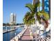 Peaceful waterfront walkway with palm trees and a view of a high rise building at 12055 Gandy N Blvd # 243, St Petersburg, FL 33702