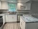 Modern kitchen with white cabinets, granite island and stainless steel appliances at 1311 4Th W St, Palmetto, FL 34221