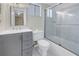 Modern bathroom with gray vanity, tiled shower, and bathtub at 3500 Lake Bayshore Dr # K-101, Bradenton, FL 34205