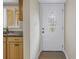White door entryway with oval glass and kitchen peek at 3500 Lake Bayshore Dr # K-101, Bradenton, FL 34205