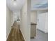Hallway view of living room and kitchen with wood-look floors at 3500 Lake Bayshore Dr # K-101, Bradenton, FL 34205