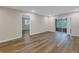 Living area with wood-look floors and access to another room at 3500 Lake Bayshore Dr # K-101, Bradenton, FL 34205