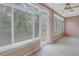 Bright sunroom with tiled floors, ceiling fan, and sliding glass doors at 3500 Lake Bayshore Dr # K-101, Bradenton, FL 34205