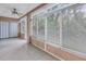 Bright sunroom with tiled floors, ceiling fan, and sliding glass doors at 3500 Lake Bayshore Dr # K-101, Bradenton, FL 34205