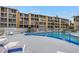 Community pool with plenty of lounge chairs at 3500 Lake Bayshore Dr # K-101, Bradenton, FL 34205