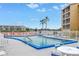 Community pool with lounge chairs and tables at 3500 Lake Bayshore Dr # K-101, Bradenton, FL 34205